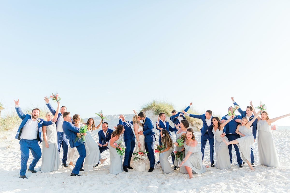Wedding To-Do List | Wedding party jumps on the beach at Hilton Clearwater Resort